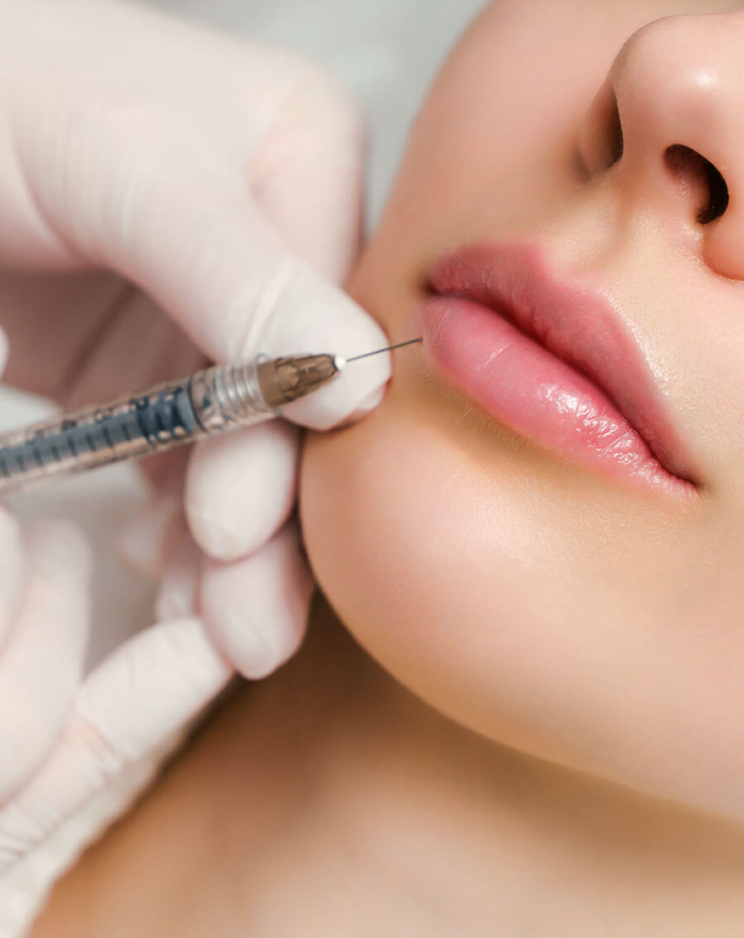 Doctor performing lip filler procedure on the patient